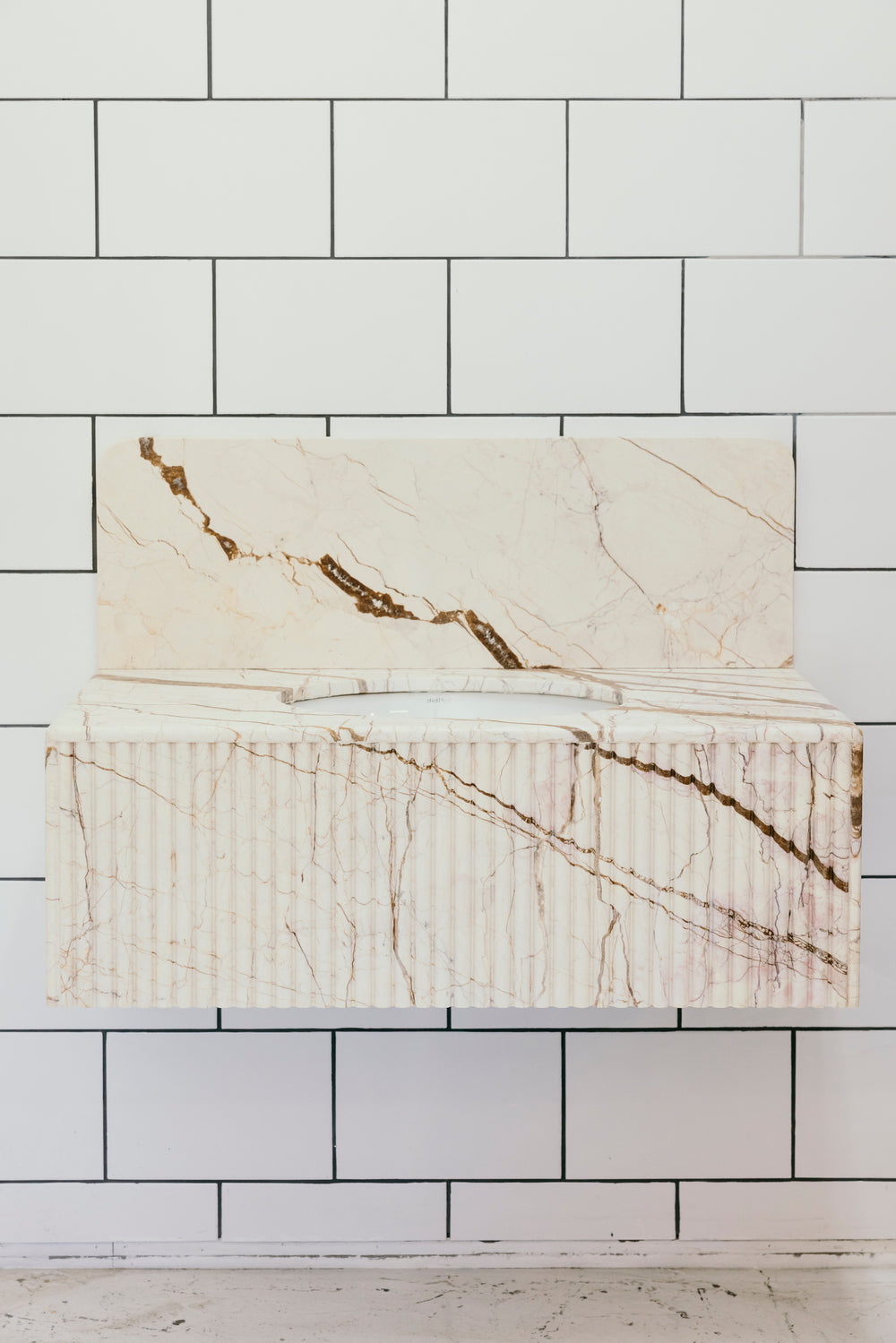 Marble-patterned tile against a white tiled wall