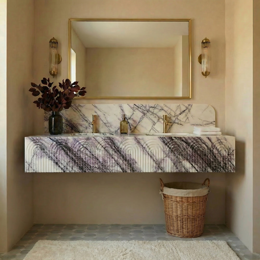 Marble-patterned vanity with a mirror, lights, and a basket in a bathroom setting.