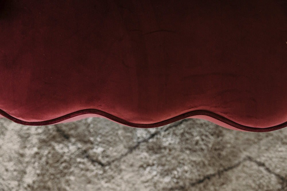 Close-up of a maroon cushion on a textured surface