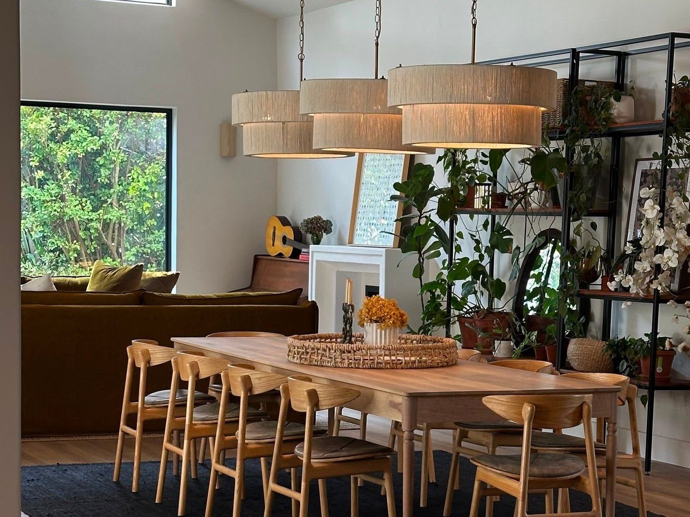 A dining room set with a long oak table and chairs
