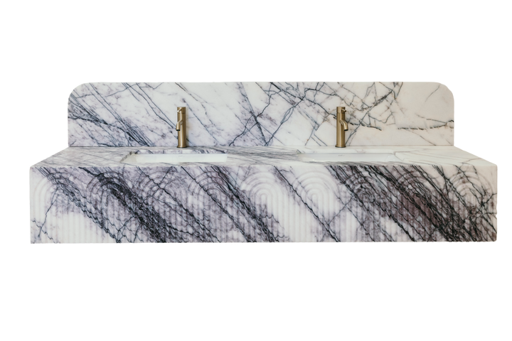 Marble-patterned bed with brass fixtures on a white background