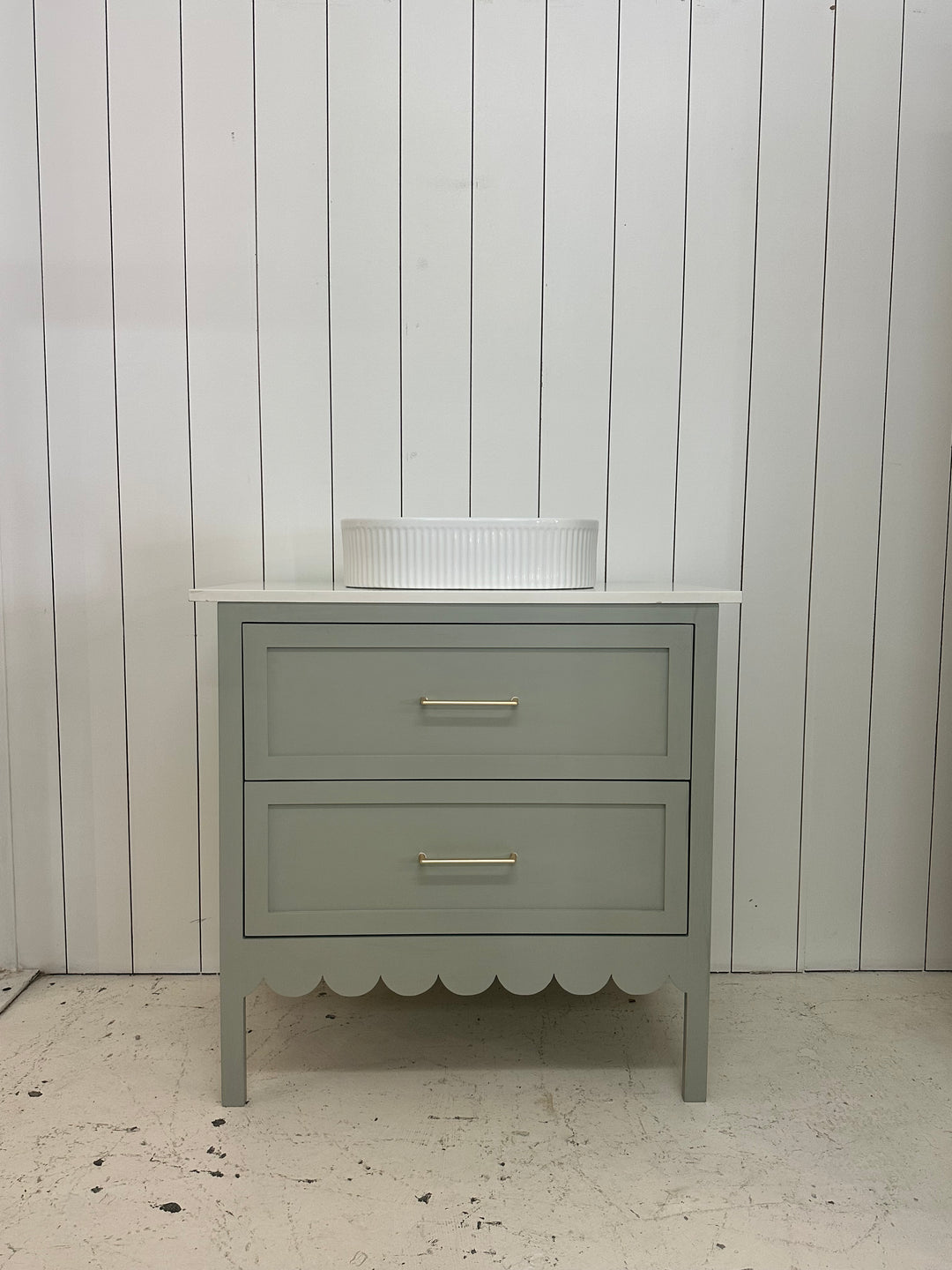 Gray wall-mounted cabinet against a light gray wall