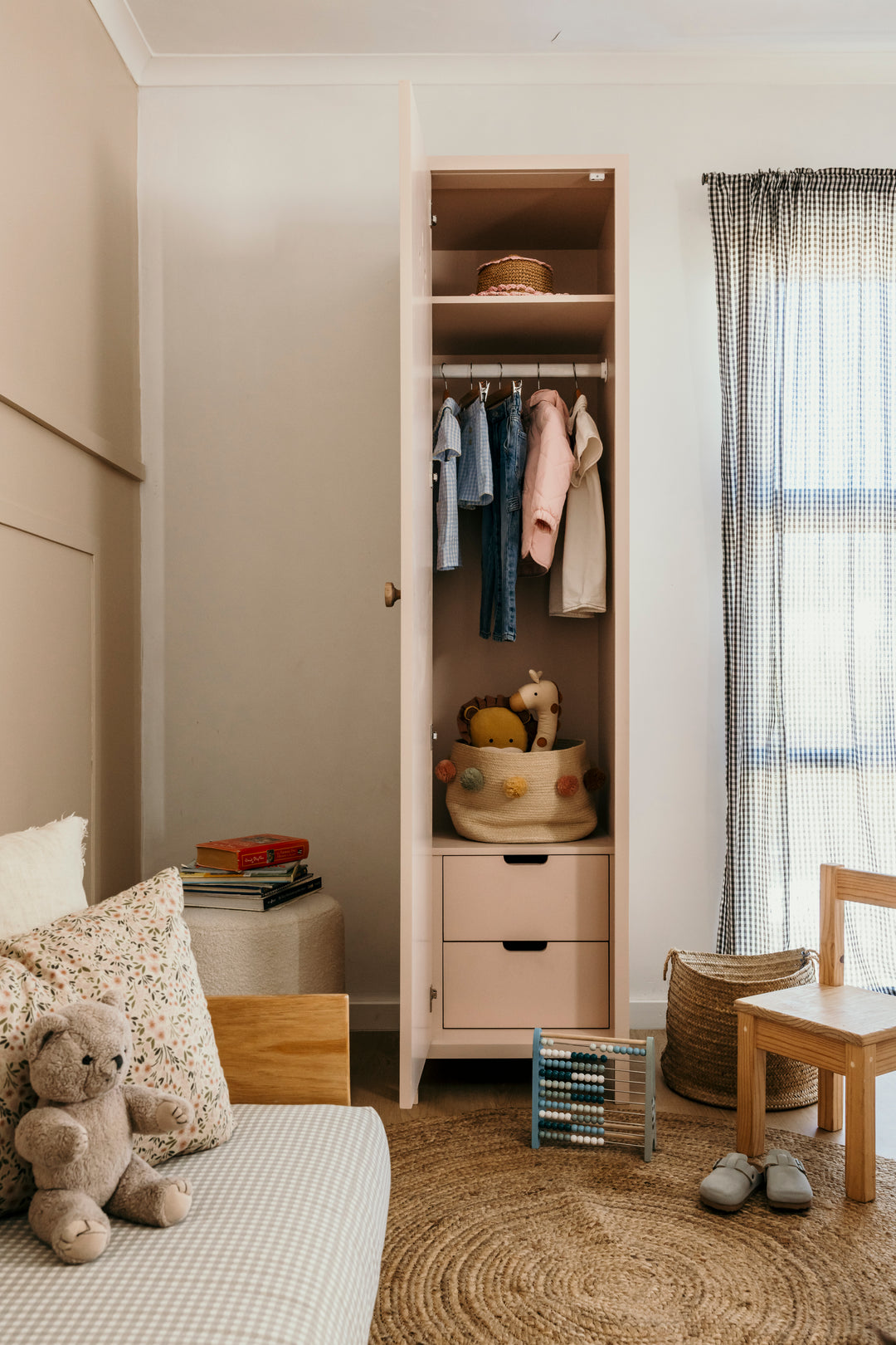 Children's room with a wardrobe, bed, and toys.