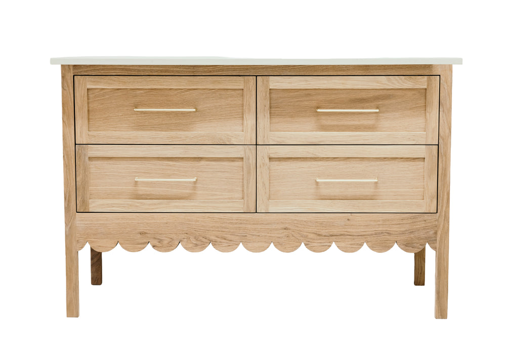 Wooden dresser with four drawers on a white background