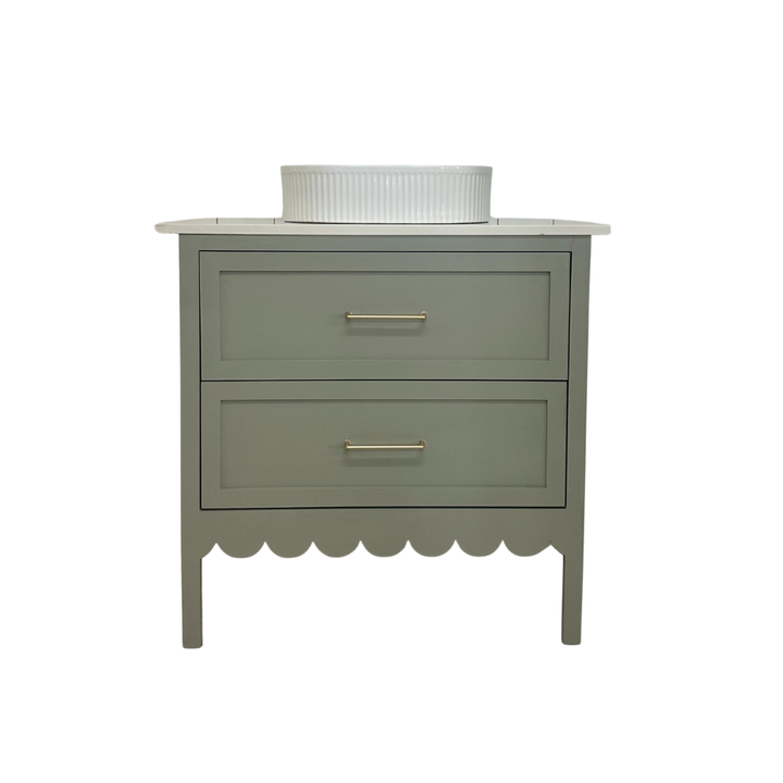 Green vanity with two drawers and a white basin on a white background