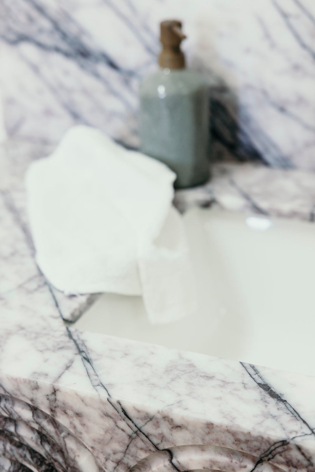 Bottle and white cloth on a marble surface