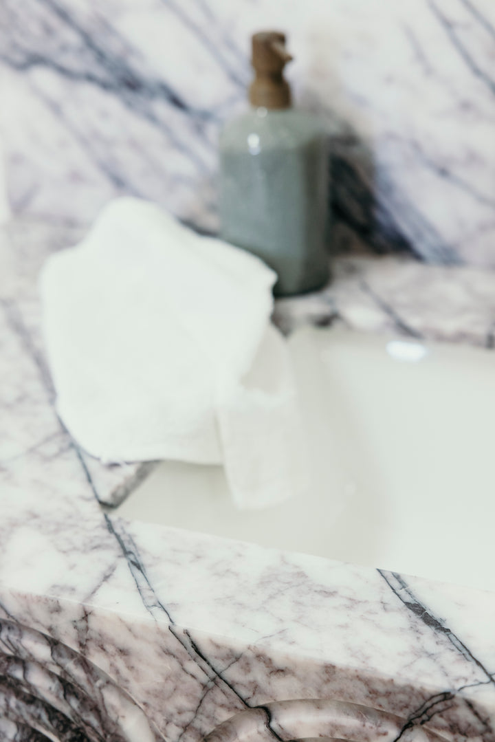 Bottle and white cloth on a marble surface