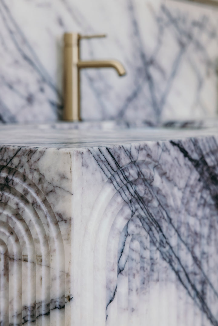 Marble countertop with a gold faucet