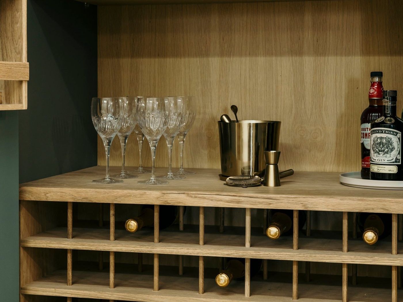 Glassware and a wine rack inside a drinks cupboard